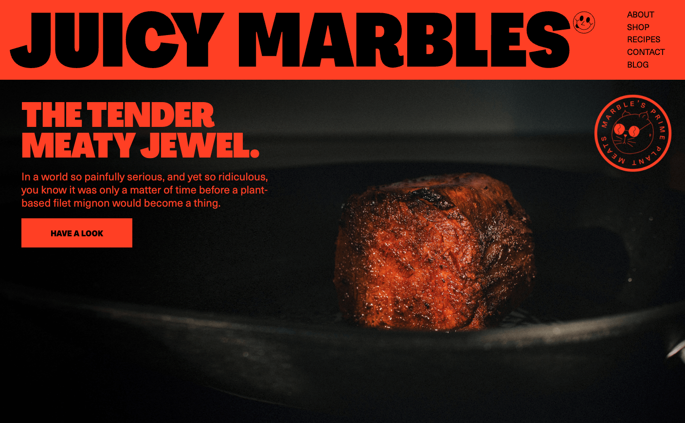 Big red and black text dominates the homepage image with a photos of Juicy Marble's succulent faux filet mignon.