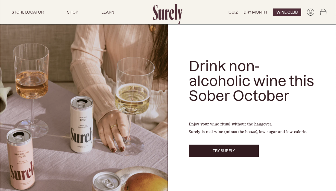 Off-white navigation bar across top of screen, with hero image on left of screen showing someone holding a glass of 'wine' and a can of Surely